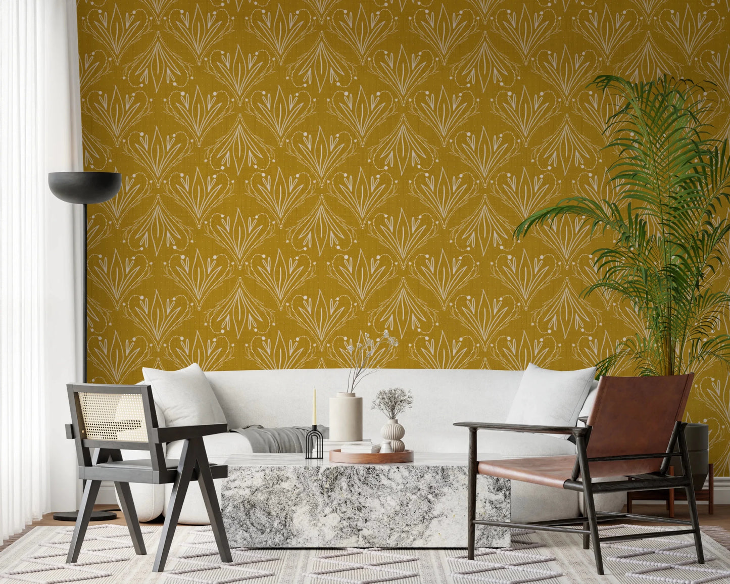 Boho Art Nouveau Folk Floral Mustard Gold wallpaper behind a white sofa and leather chair in a chic living room