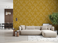Boho Art Nouveau Folk Floral Mustard Gold wallpaper behind a beige sectional sofa in an open-plan living room