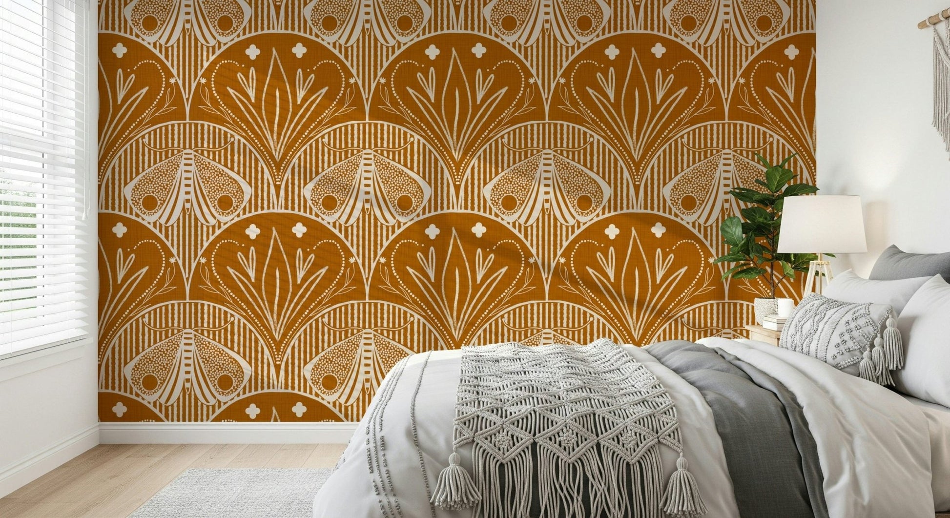 Boho Art Nouveau Scallop Butterfly Floral in Burnt Orange wallpaper mural behind a bed with a macrame throw