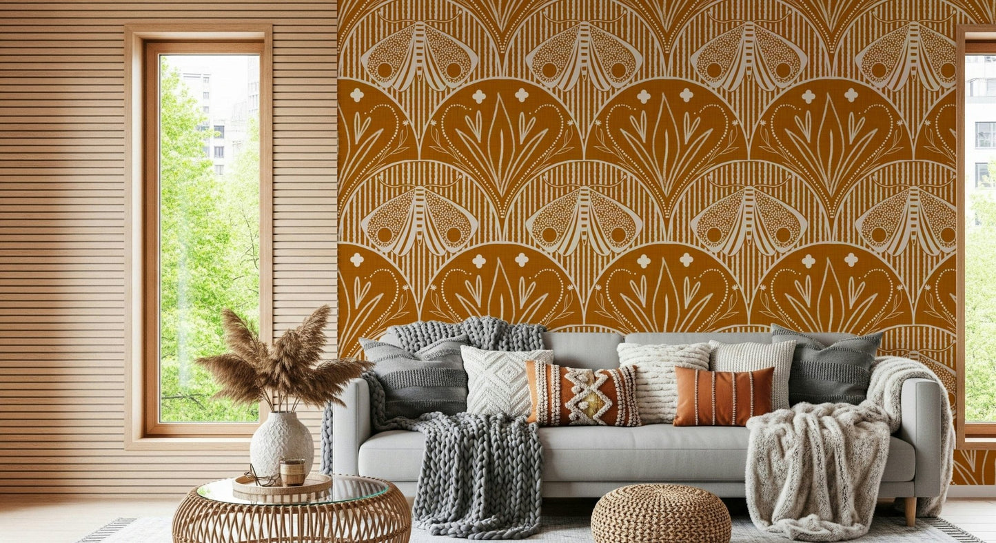 Boho Art Nouveau Scallop Butterfly Floral in Burnt Orange wallpaper mural behind a grey sofa with knit throws
