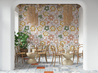 A boho blooms wallpaper featuring large retro-style flowers in muted green, mustard, and blush tones.