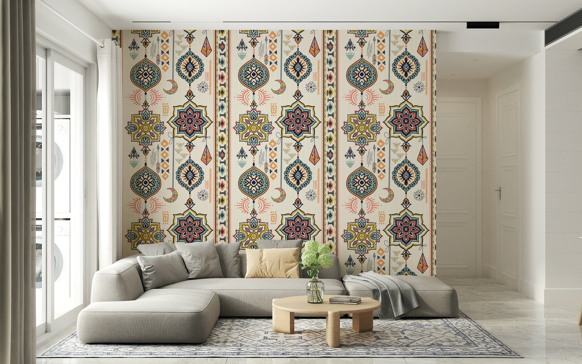 Boho Charms wallpaper with teal and gold medallions behind a grey sectional sofa in a bright living room