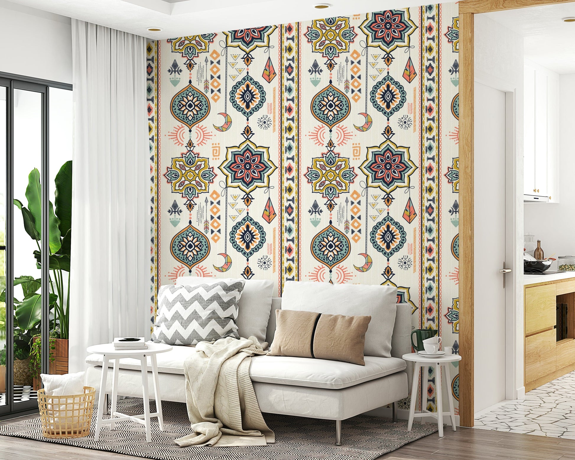 Boho Charms wallpaper behind a white sofa with chevron and tan cushions in a plant-filled living room