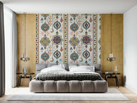Boho Charms wallpaper above a grey upholstered bed framed by wood panels in a warm bedroom