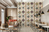 Boho Charms wallpaper with colourful medallions in a modern cafe with wood chairs and terrazzo floor