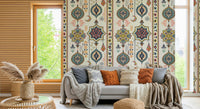 Boho Charms wallpaper behind a grey sofa with rust cushions and pampas grass in a cosy living room