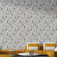Golden and silver foil feathers on wallpaper


