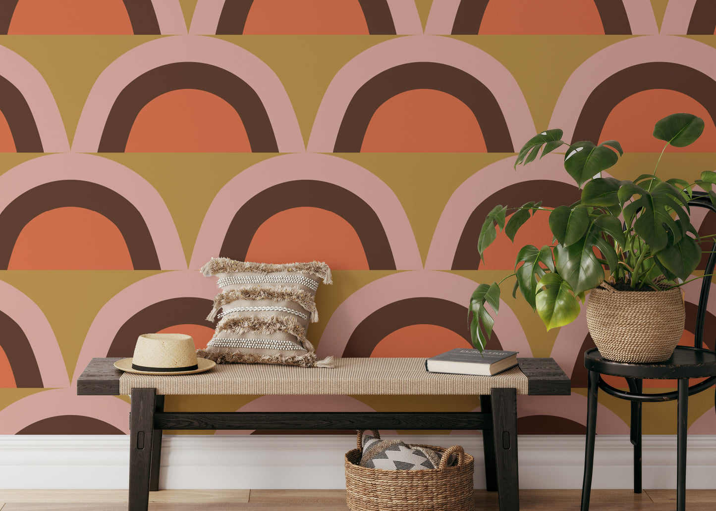 Boho Pink Apricity wallpaper with retro terracotta and pink arch scallops behind a wood bench in a hallway