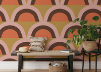 Boho Pink Apricity wallpaper with retro terracotta and pink arch scallops behind a wood bench in a hallway