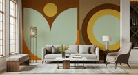 Boho Sun and Moon wallpaper mural in rust and sage behind a cream sofa and gold floor lamp in a bright living room