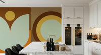 Boho Sun and Moon wallpaper mural with rust and sage geometric shapes beside a marble island in a white kitchen