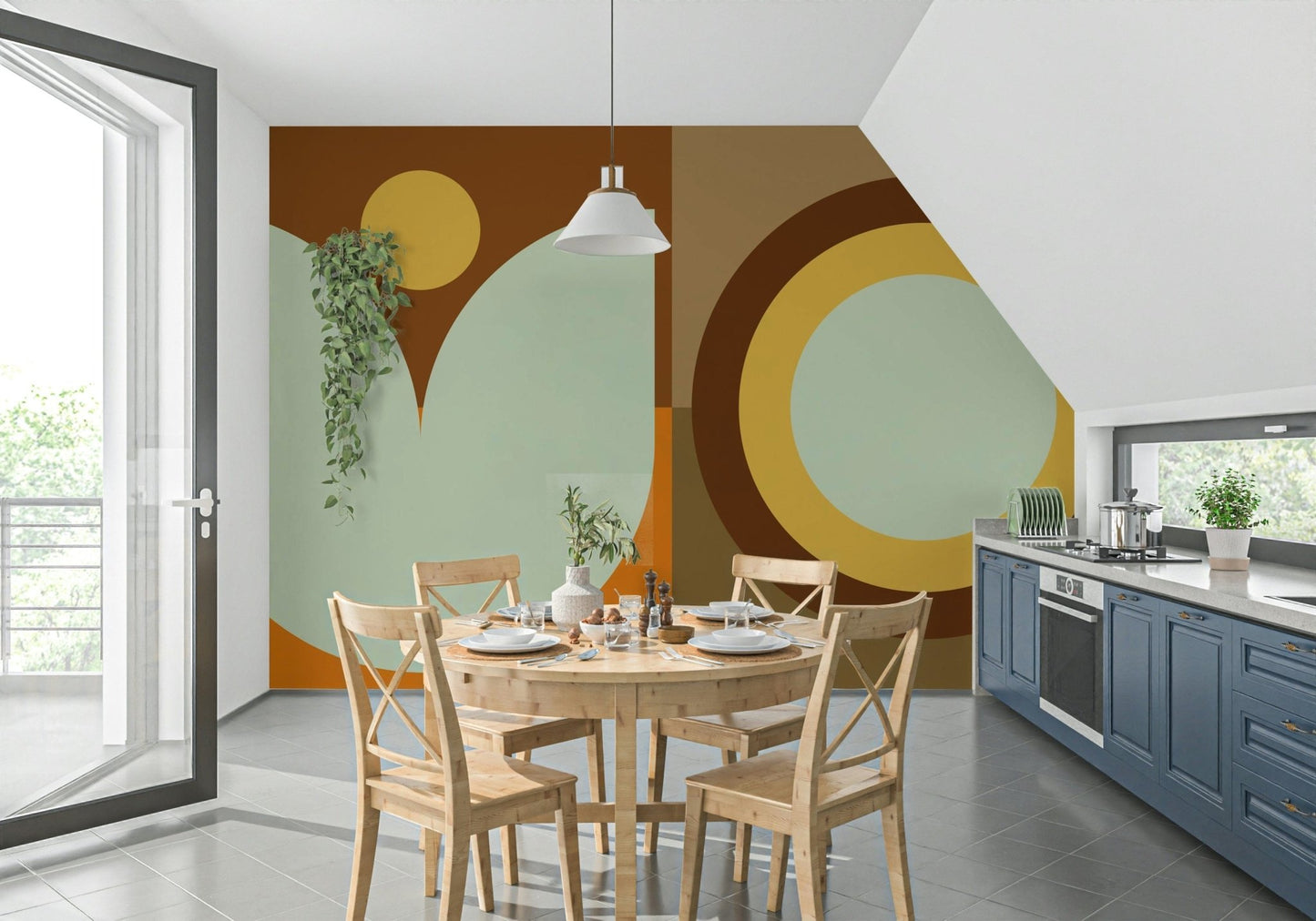 Boho Sun and Moon wallpaper mural in brown and sage behind a wood dining table and blue kitchen cabinets
