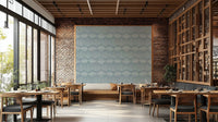 Boho Waves On Arona Canvas wallpaper as a blue feature panel on brick in a restaurant with wood tables and chairs
