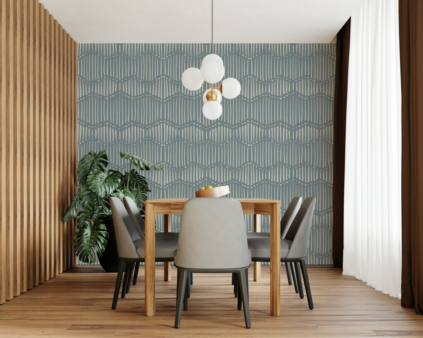 Boho Waves On Arona Canvas wallpaper in slate blue behind a wood dining table, grey chairs and globe chandelier