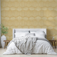 The mural is installed in a calm, bohemian living room behind a simple, light-colored sofa.


