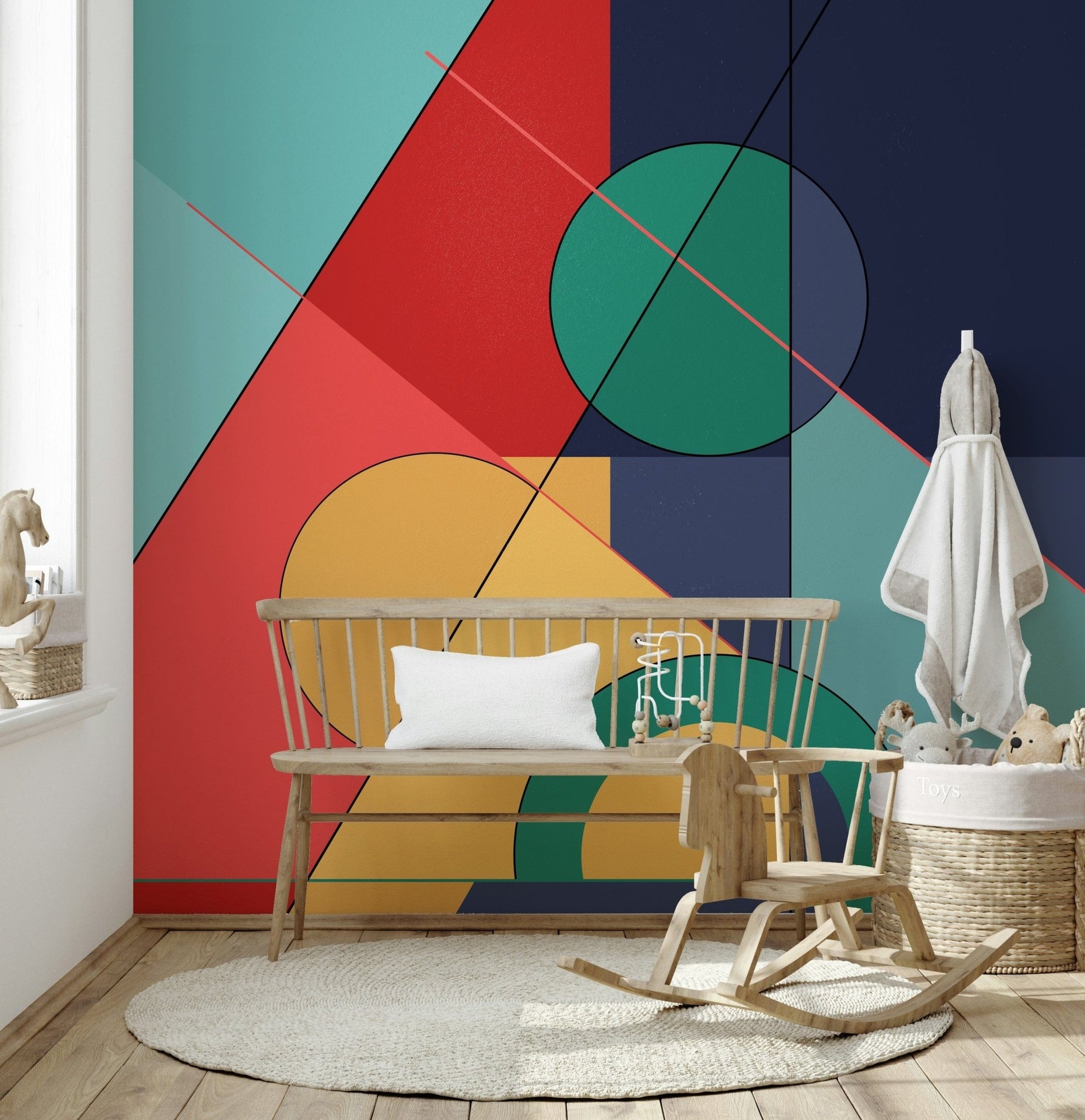 Bold Bauhaus wallpaper mural of bold shapes in a nursery with a wood bench and rocking horse