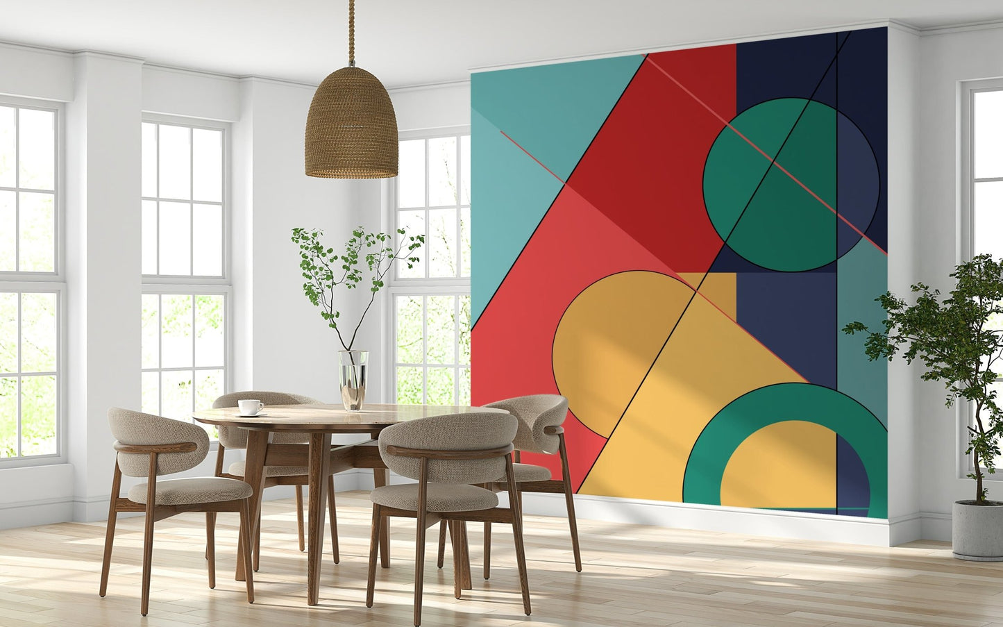 Bold Bauhaus wallpaper mural of geometric shapes behind a round wood table with boucle chairs