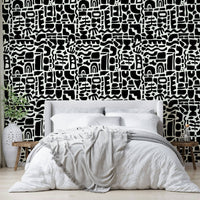 The design is an abstract collage of overlapping shapes.
