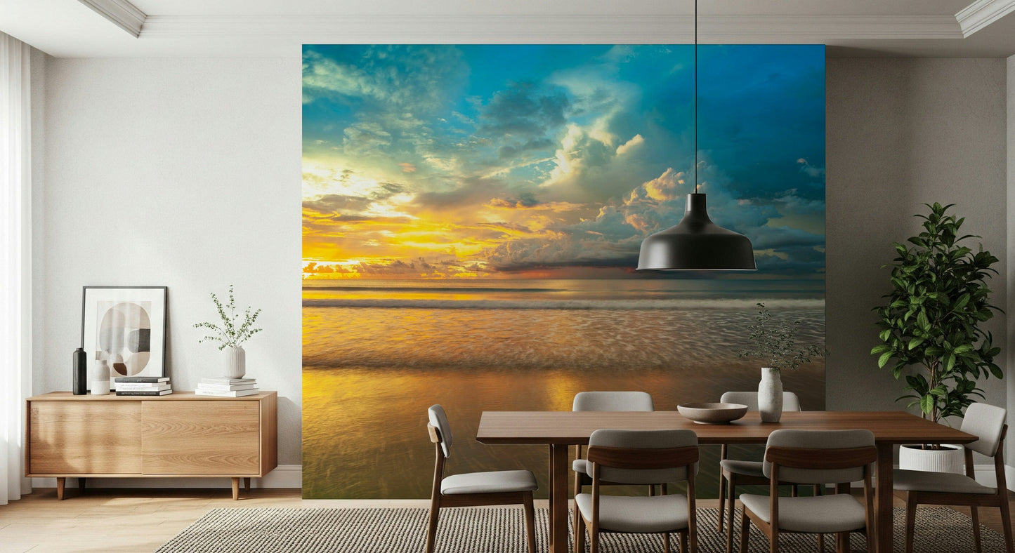Warm sunlight breaking through thick clouds over a reflective shore in a stunning Borneo Beach wallpaper.