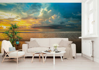 A calm tropical horizon with gentle waves and dramatic storm clouds shown in the Borneo Beach wallpaper.