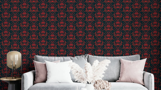 Stylized Botanical Damask wallpaper in deep red on navy behind a grey sofa with blush cushions in a living room