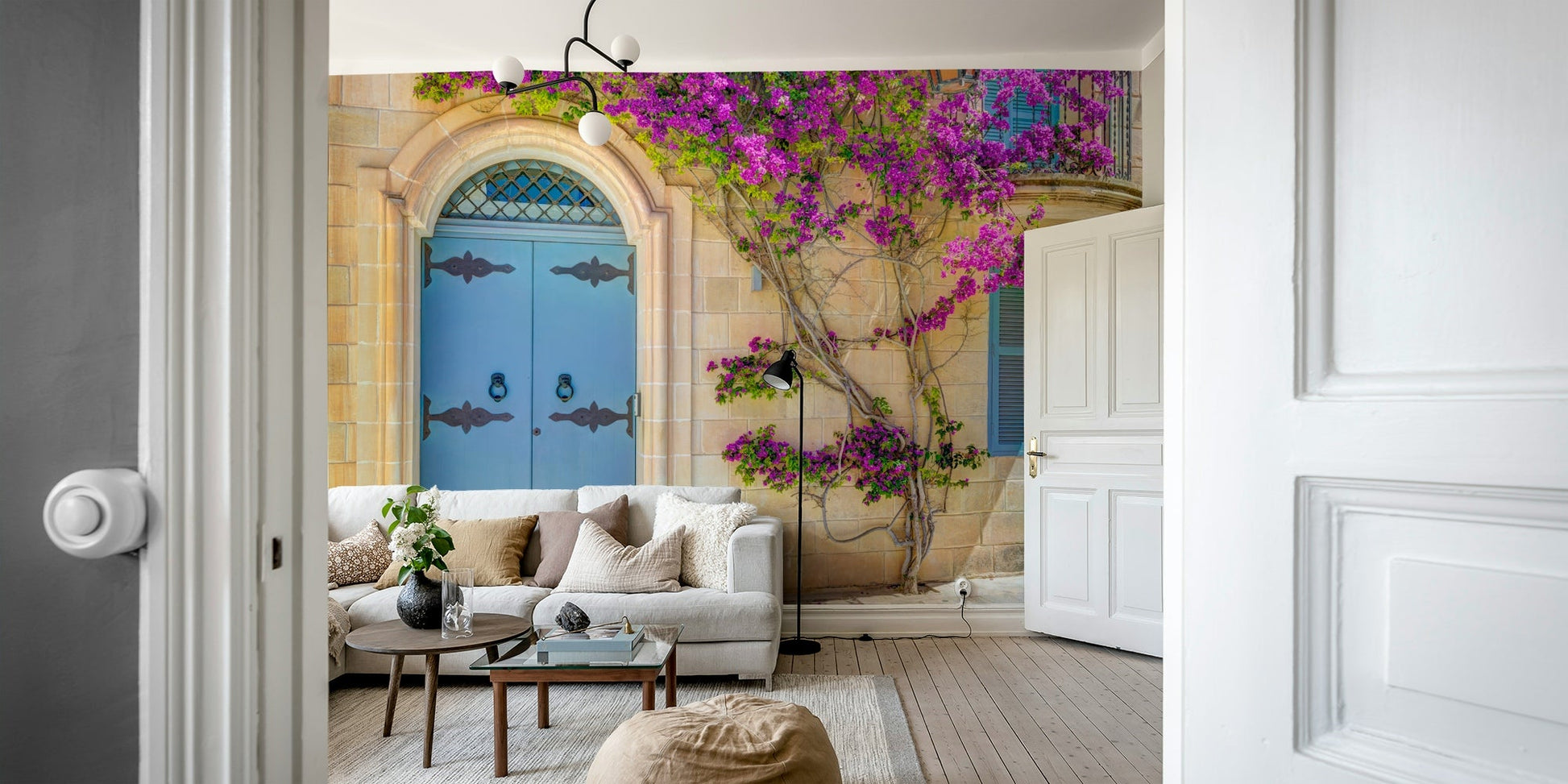 The image shows a charming door surrounded by vibrant pink and purple blossoms.

