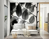 An artistic leaf pattern mural on minimalist wallpaper.


