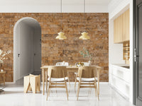 Brickwork Beauty wallpaper mural in tan stone beside an arched doorway in a bright wood-toned dining room