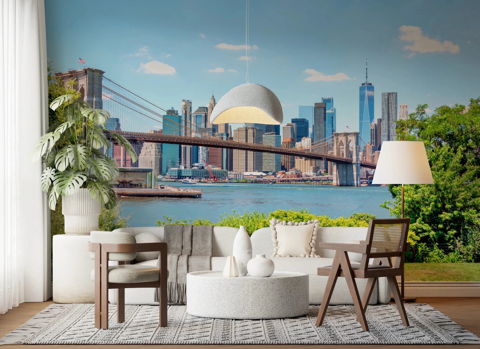 Bridge to Manhattan wall mural of the Brooklyn Bridge skyline behind a white boucle sofa and terrazzo table