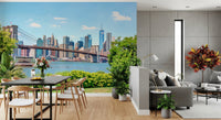Bridge to Manhattan wall mural of the Brooklyn Bridge skyline beside a black dining table and wood chairs