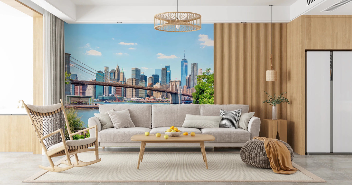 Bridge to Manhattan wall mural of the bridge and skyline behind a beige sofa and wood rocking chair in a living room