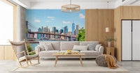 Bridge to Manhattan wall mural of the bridge and skyline behind a beige sofa and wood rocking chair in a living room