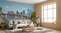 Bridge to Manhattan wall mural of the Brooklyn Bridge skyline behind a white sofa and rattan round table