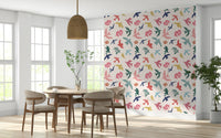 Bright Freedom Birds wallpaper behind a round wood dining table and rattan pendant light