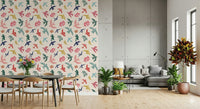 Bright Freedom Birds wallpaper behind a dark dining table beside a grey sectional and concrete wall