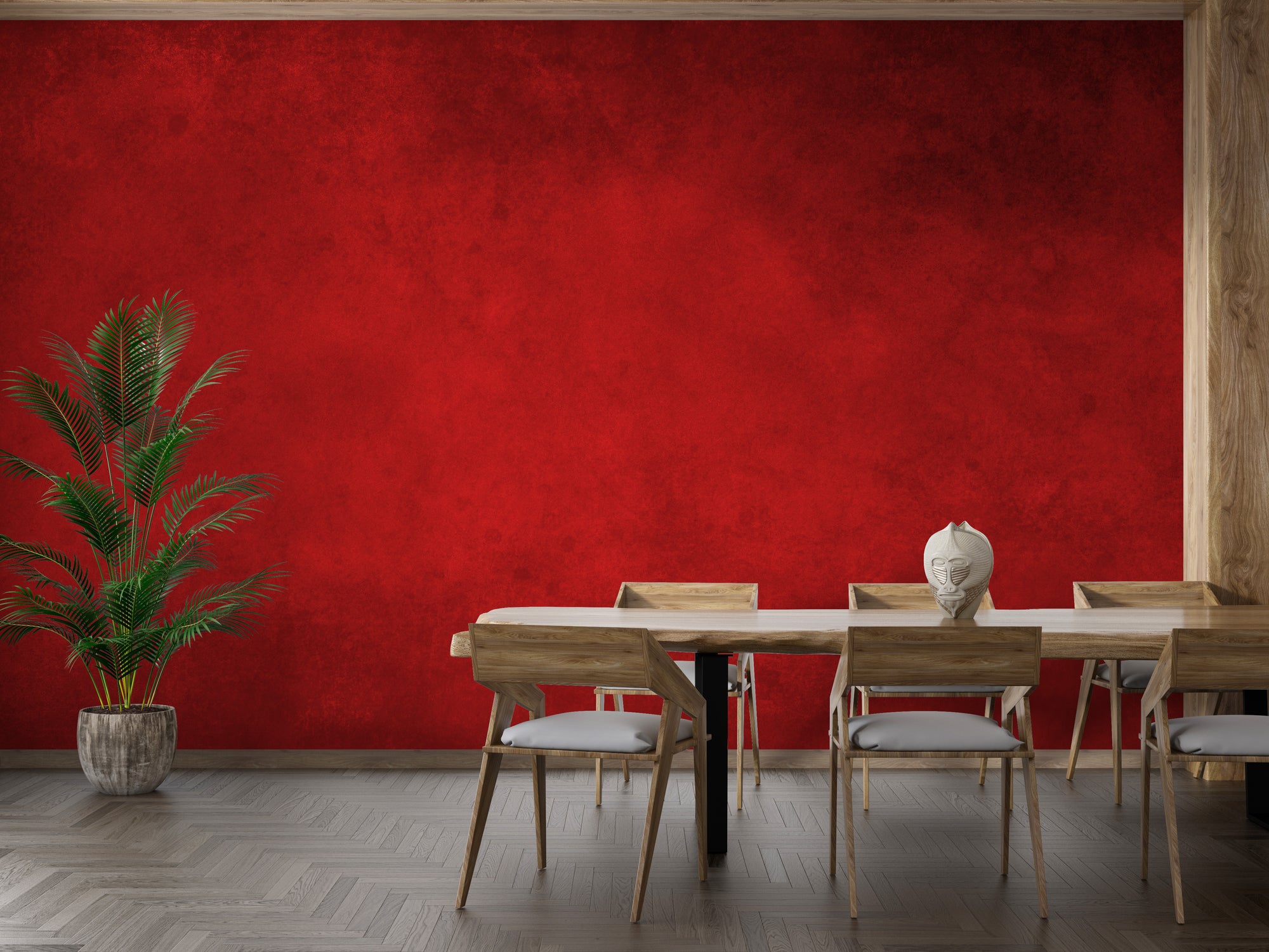 Bright Red Concrete Pattern wallpaper mural on a dining room wall with a wooden table, chairs and potted palm