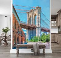 Brooklyn Bridge Vista wallpaper mural of the stone tower and warehouse behind a grey upholstered bench in an entryway