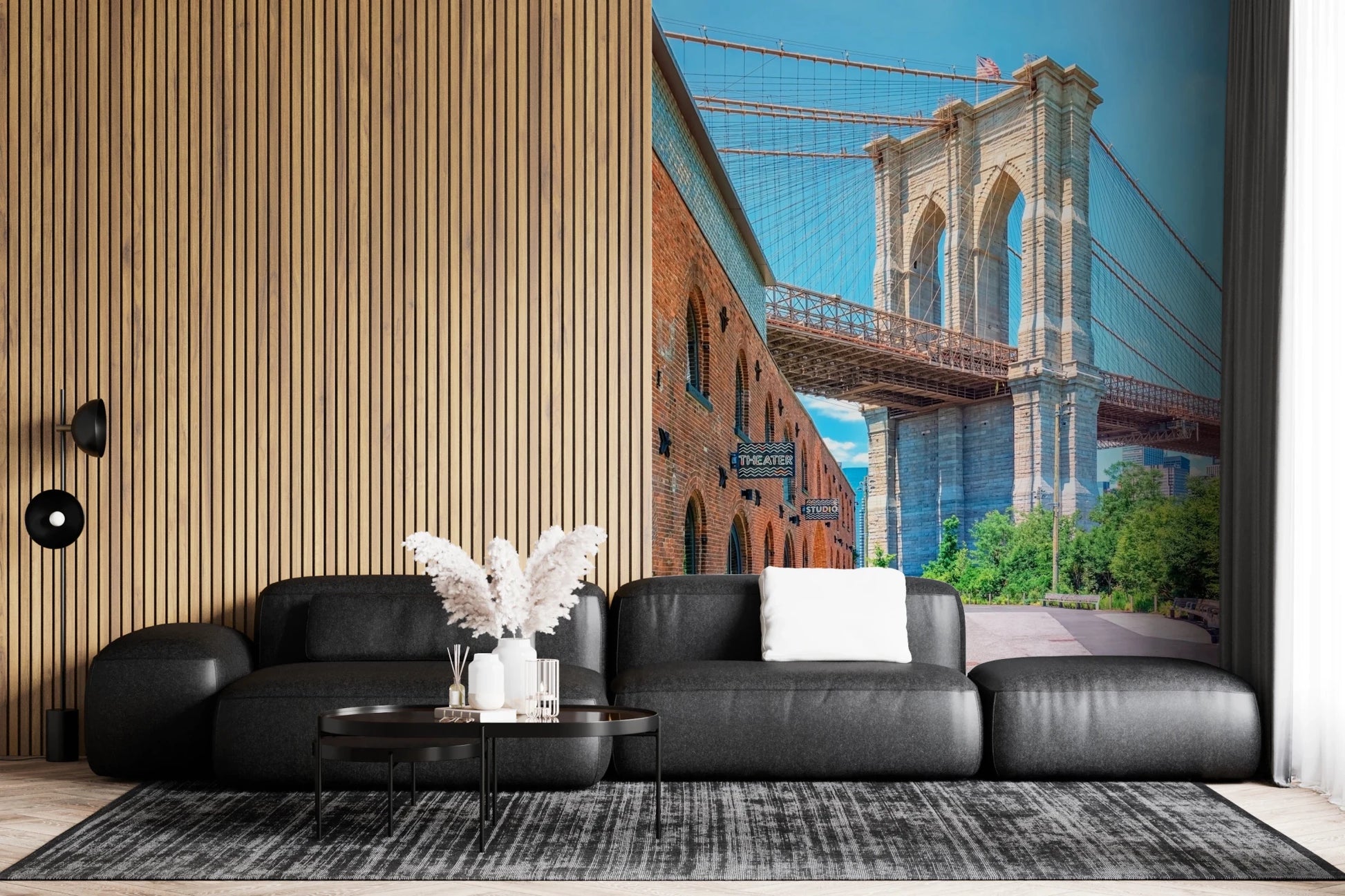 Brooklyn Bridge Vista wallpaper mural showing the bridge and brick building above a black leather sectional and slatted wall