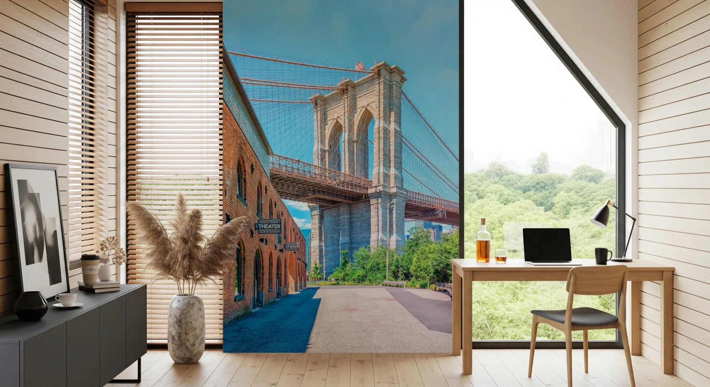Brooklyn Bridge Vista wallpaper mural with the bridge and brick building behind a wood desk and laptop in a home office