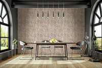 Brown Animal Dot Jewel Jungle wallpaper in a dining room with a wooden table, arched windows and figure sculptures