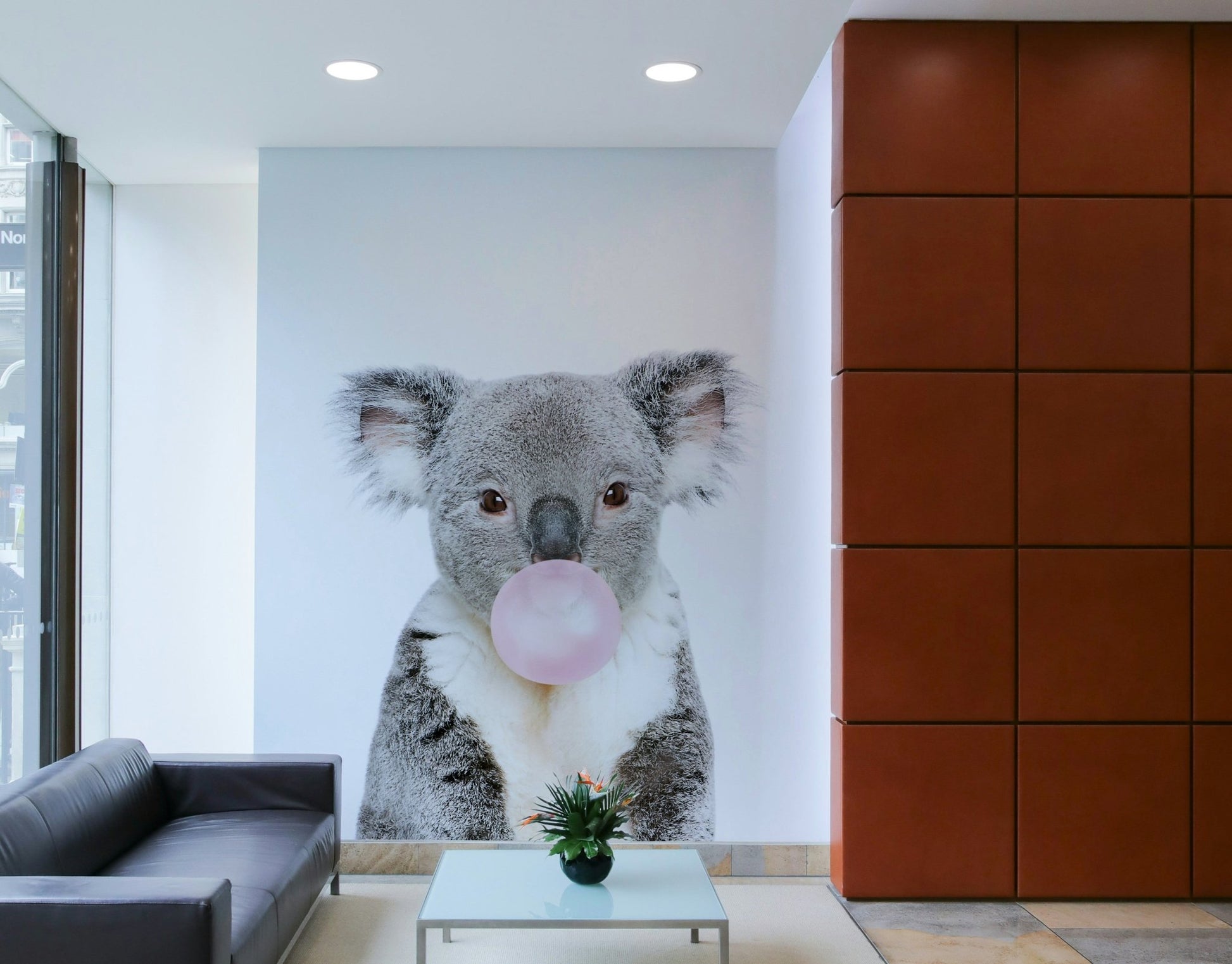 Whimsical koala with bubble gum captured in a vibrant wall mural.

