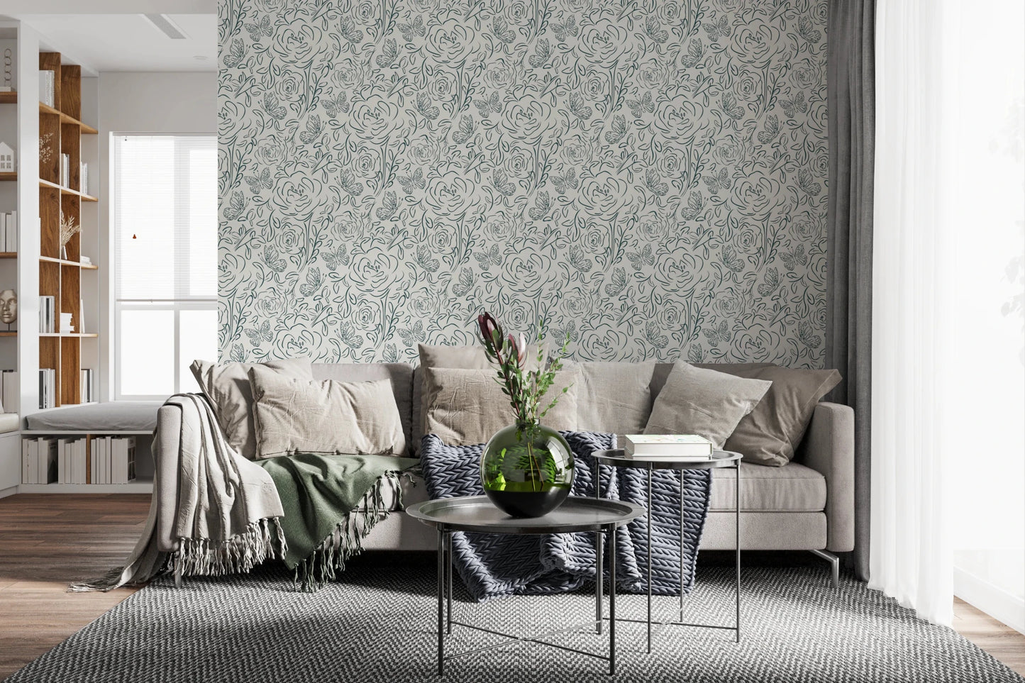 Butterfly Bloom Line Art wallpaper behind a beige sectional with protea blooms and dark round tables