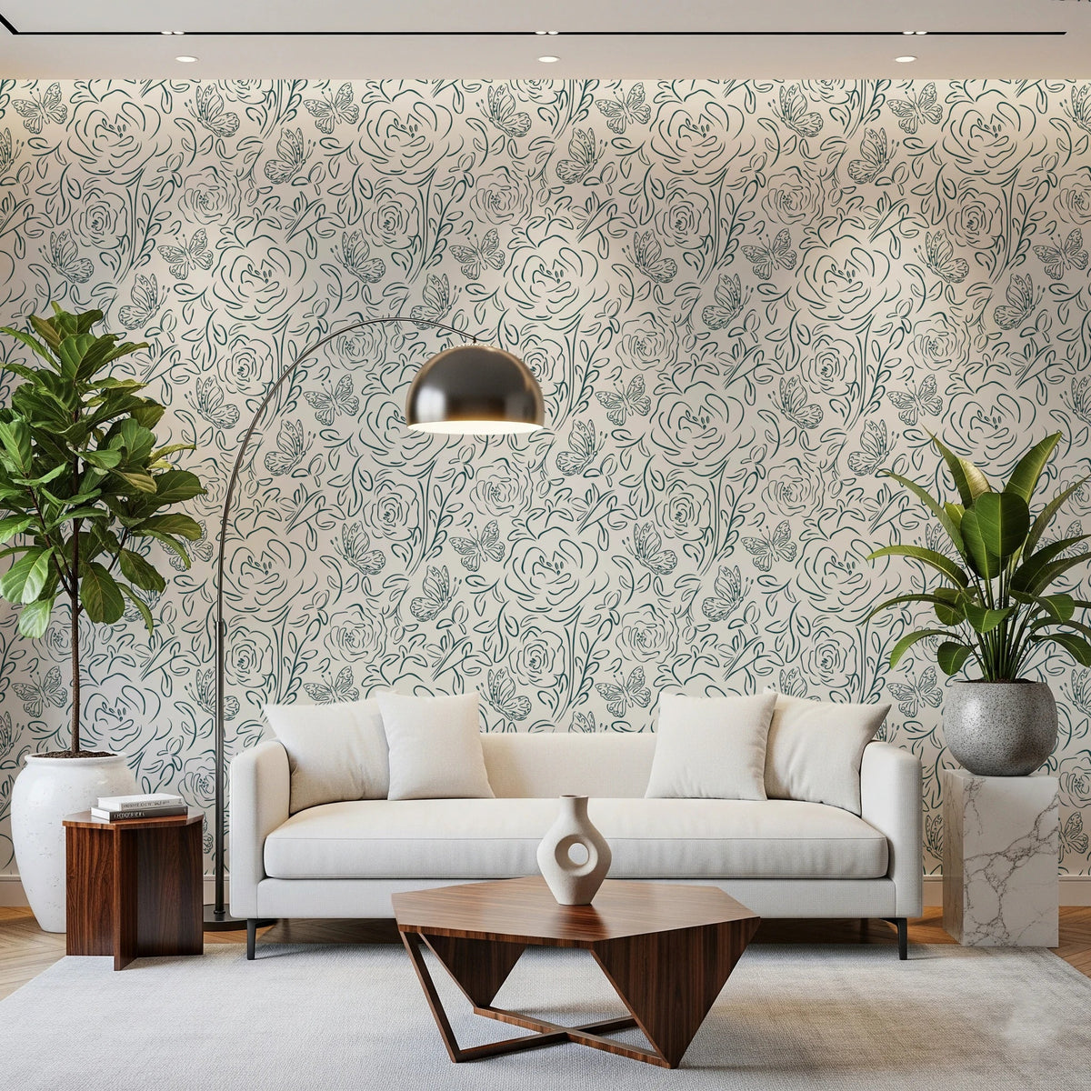 Butterfly Bloom Line Art wallpaper in teal roses behind a cream sofa with arc lamp and leafy plants
