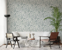 Butterfly Bloom Line Art wallpaper behind a white sofa with marble table, cane chair and tall palm