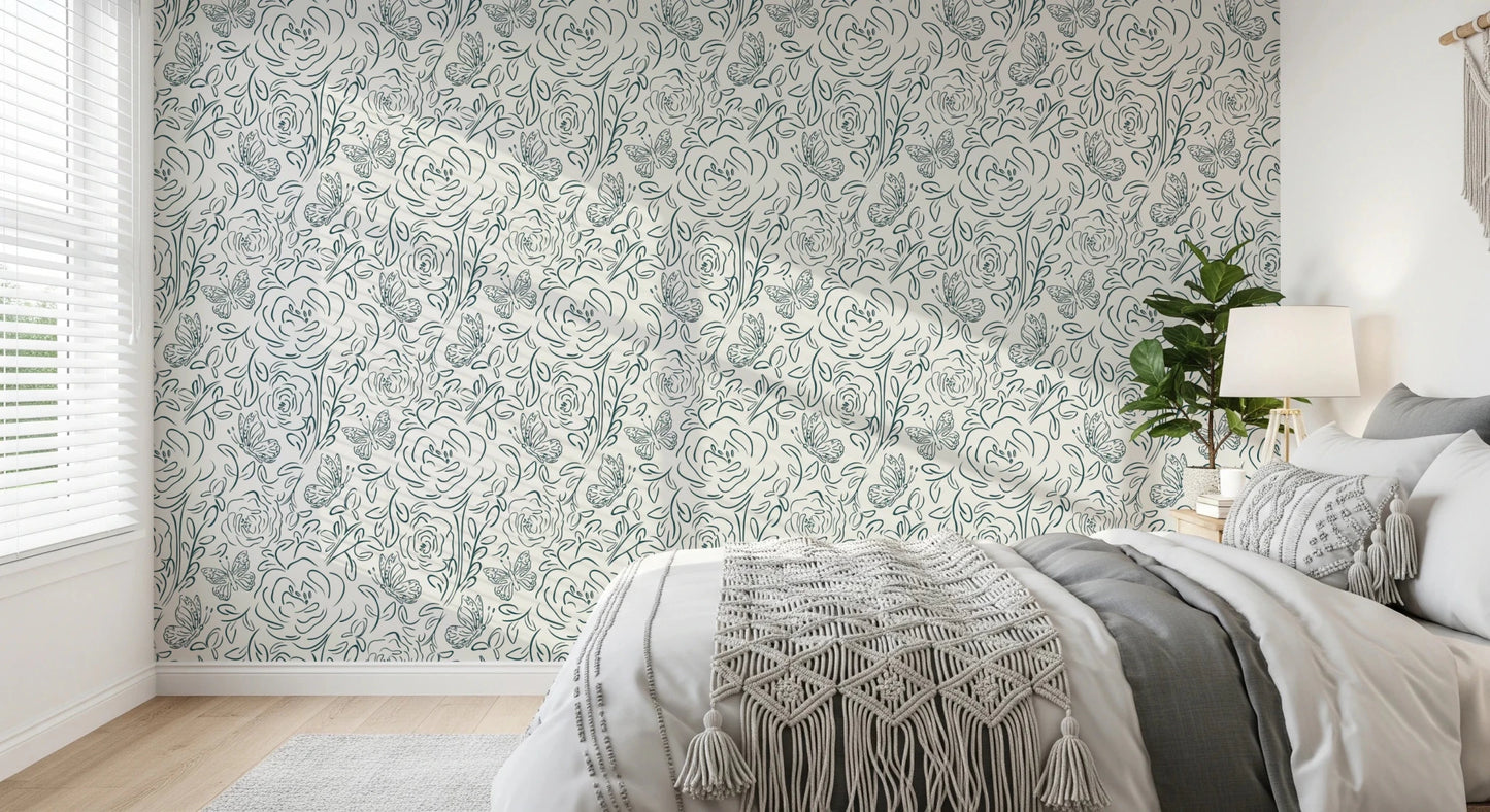 Butterfly Bloom Line Art wallpaper in a bedroom with grey bedding, macrame throw and a leafy plant