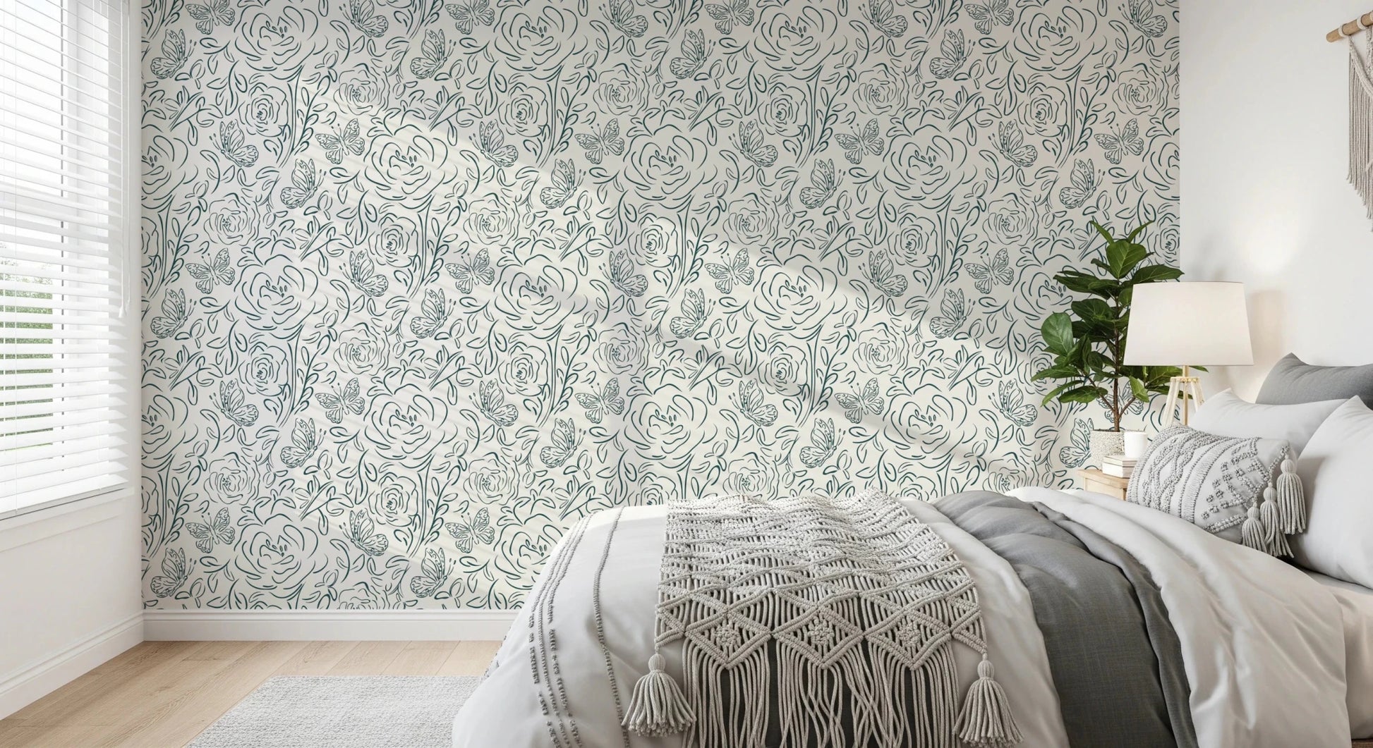 Butterfly Bloom Line Art wallpaper in a bedroom with grey bedding, macrame throw and a leafy plant