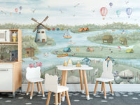 Breezy Shores wallpaper mural of a lakeside windmill scene in a kids playroom with white bear chairs and a toy kitchen