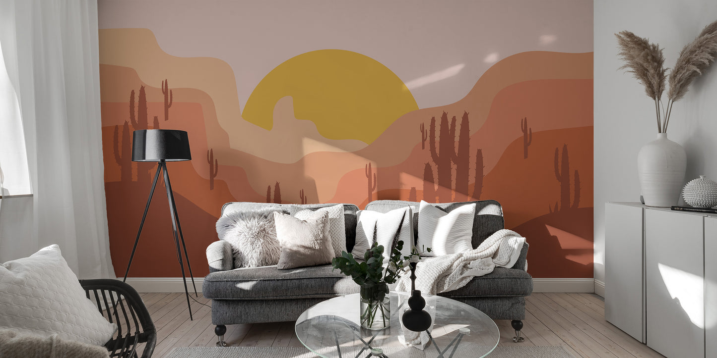 Self adhesive desert landscape wall mural behind a dark grey sofa in a modern lounge area with a stylish floor lamp.