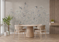 Enchanted Aviary Ballet mural of birds and meadow flowers behind a round wood dining table and beige chairs