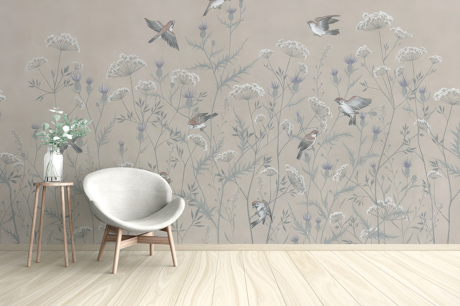 Enchanted Aviary Ballet mural of beige wildflowers and birds behind a white egg chair in a living room